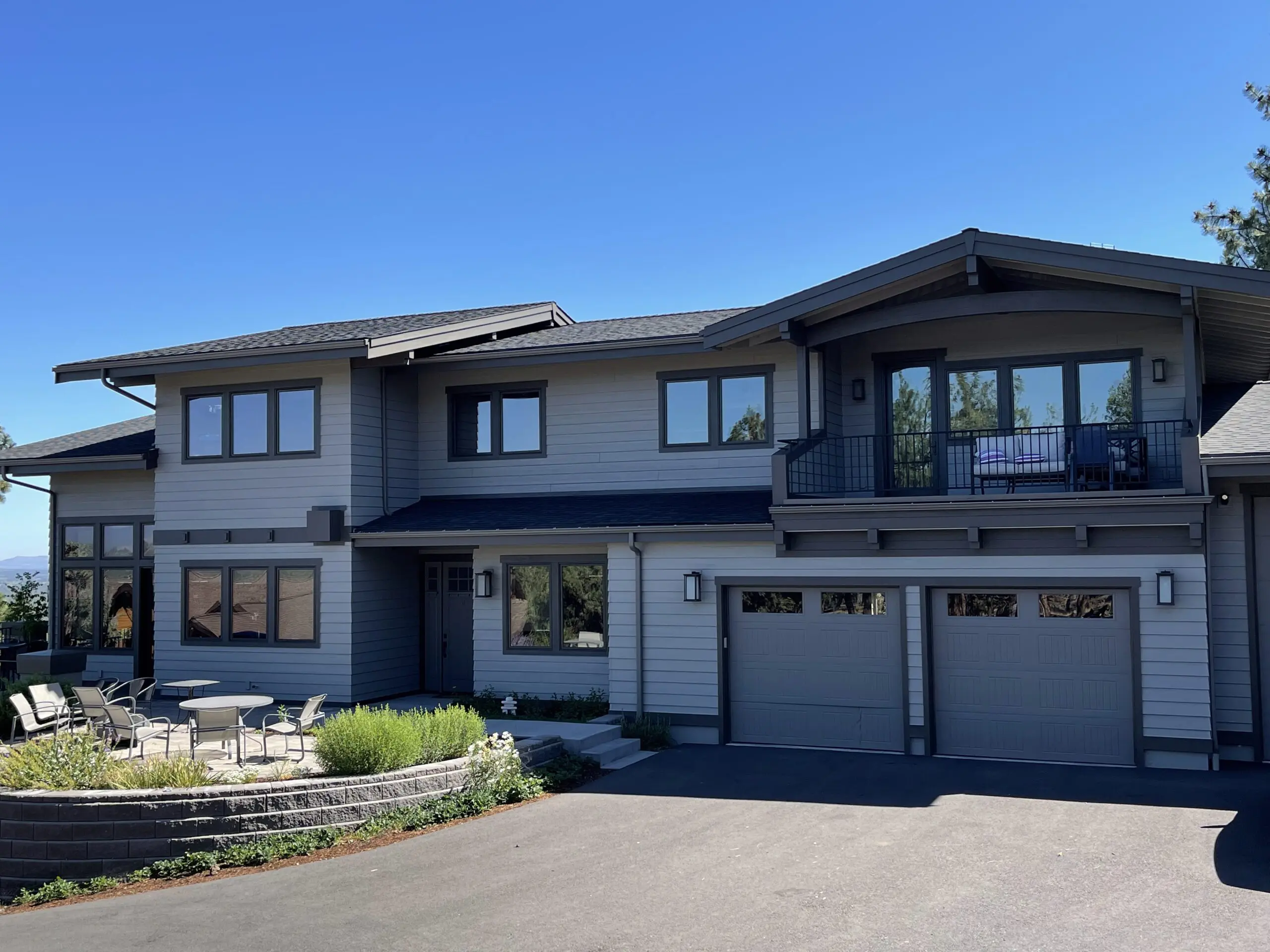 modern two-story home with gray and white exterior showing best exterior paint for Bend Oregon climate