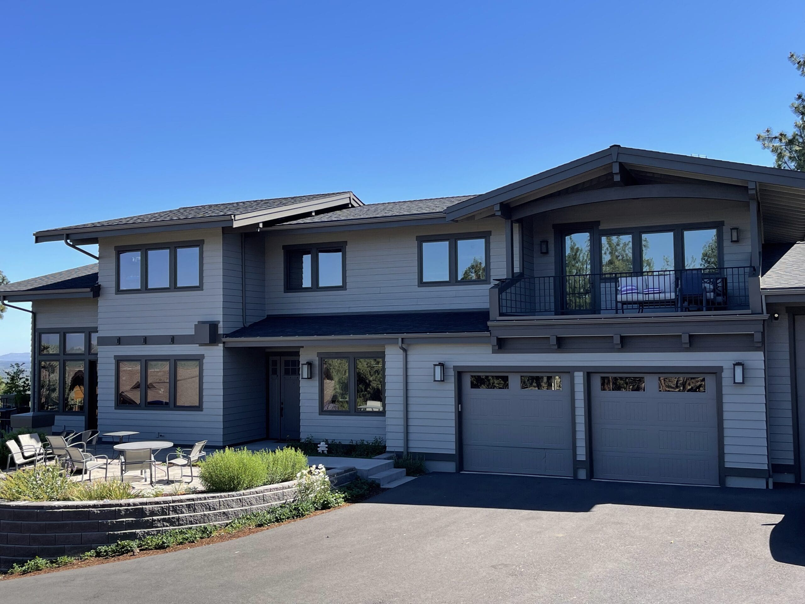 modern two-story home with gray and white exterior showing best exterior paint for Bend Oregon climate