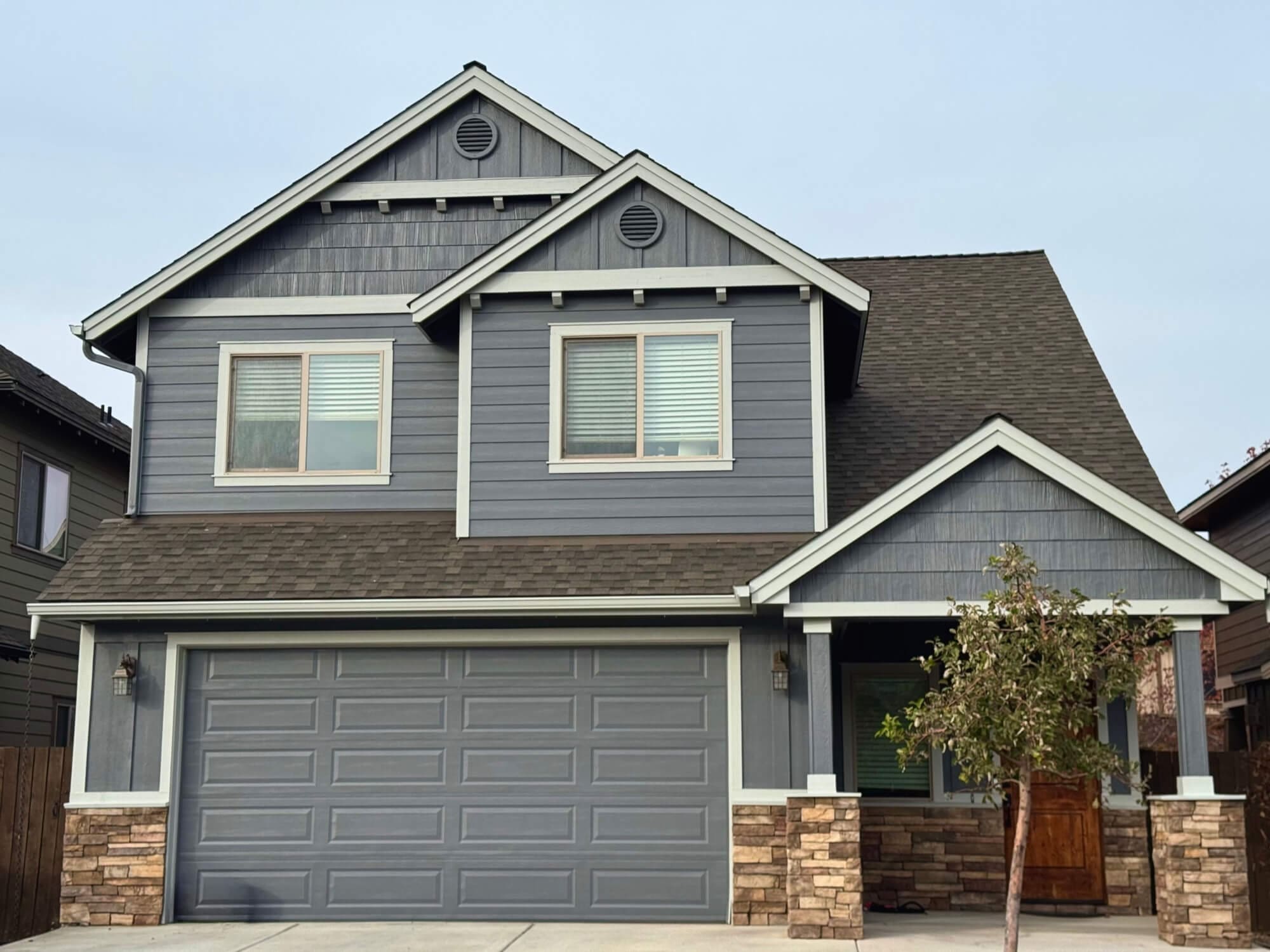 two-story craftsman home with blue gray siding and white trim completed by West Rivers Painting in Bend Oregon